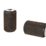 Two brown cylindrical abrasive drum brushes with bristle texture, standing on white background—likely grinding or deburring tools.